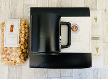 Load image into Gallery viewer, black &#39;BREW.&#39; coffee mug, cold brew caramel popcorn,  two mini sugar cookies, Columbian medium roast pour over coffee gift set. Packaged in black box with black and white bow
