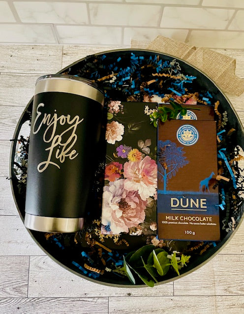 Black 20 oz. ENJOY LIFE tumbler,  black floral Journal with matching pen, W. African chocolate bars packed in a round decorative table tray
