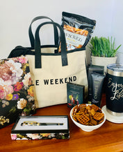 Load image into Gallery viewer, Let her know that you got her by treating her to this loaded gift that's packaged in a trendy canvas tote.  It includes a deluxe floral journal/diary with matching pen, ultra hydrating hand crème, 20oz. "Enjoy Life" Tumbler, Spicy Snack Mix, Cosmo drink mix (make 2-3 glasses), and an oversized scarf (choose plum or black).  Gift you wife, your bestfriend, sister, mother, girlfriend, or aunt.  Gifts for her. Travel gift